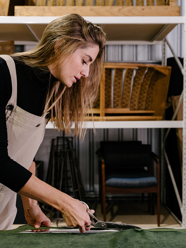 Reioni Douglas of Culture Cush in Newcastle working in her studio, cutting fabric for a custom modular lounge.