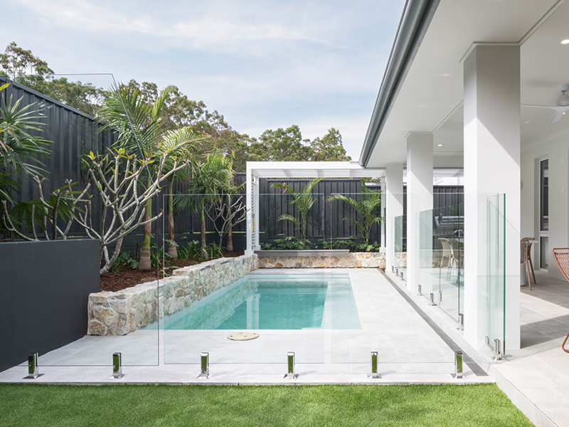 Mojo Homes backyard with pool, alfresco dining and outdoor nooks designed for year-round living.