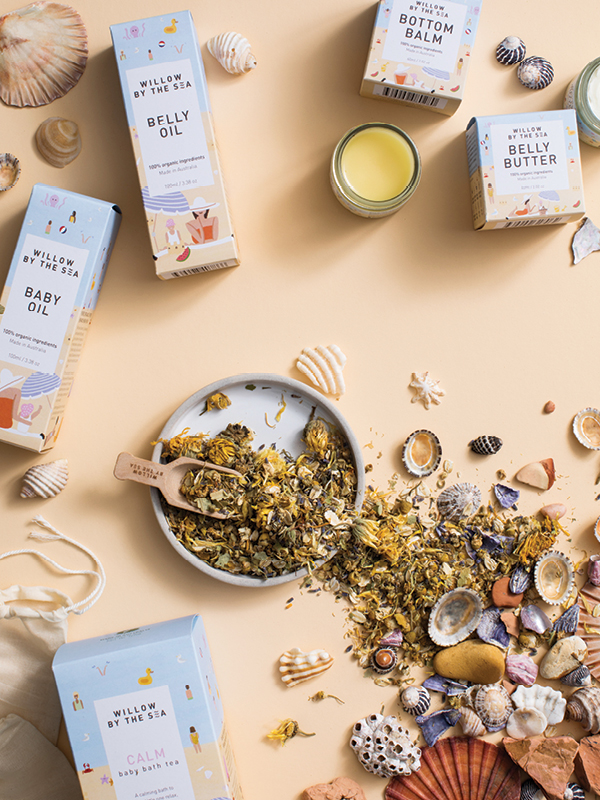 Willow by the Sea organic skincare products including belly oil, belly butter, bottom balm, baby oil, and baby bath tea with natural botanicals and seashells.